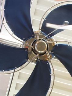 a blue and silver fan sitting on top of a ceiling