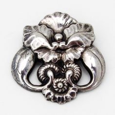 "Danish designer Georg Jensen 830 standard silver brooch in the Number 97 pattern, featuring stylized flower & leaf motifs. c. 1915-1927. This marvelous brooch is 1 3/4\" long, 1 3/4\" wide and weighs 12.4 grams. EA1087" Vintage Sterling Silver Flower Brooches, Silver Art Nouveau Brooch, Turquoise Pendant Necklace, Flower Leaf, Georg Jensen, Yellow Gold Bracelet, Silver Brooch, Turquoise Pendant, Diamond Bracelets