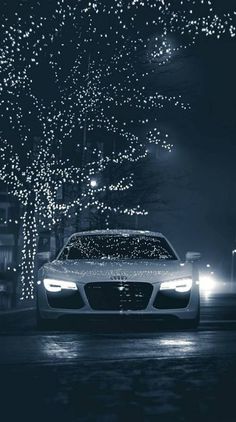 a car driving down a street covered in christmas lights