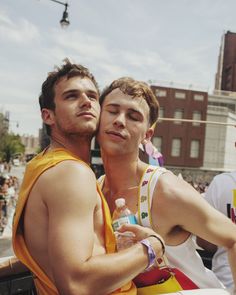 two men standing next to each other in front of a crowd