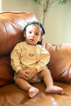 Want your baby to not only look stylish and cool but feel super comfortable? These oversized baby sweatshirts are the perfect find! Made with 95% organic cotton and 5% spandex, these bubble romper sweatshirts are the cream of the crop. To all my MLB fans, but more specifically, my San Francisco Giants fans! Faithful to the Bay! Taking baby to their first MLB game or cheering for your favorite team in the comfort of your own home? This sweatshirt is for you!  Our gender-neutral colors allow for both baby girls and baby boys to look and feel their absolute best! The sweatshirts are easy to put on and take off for diaper changes with only 3 buttons.  SWEATSHIRT COLOR: Cream THREAD COLOR: Black & Orange SIZES: 0-3m, 3-6m, 6-12m, 12-18m, 18-24m WARNING: Keep away from fire RETURNS & EXCHANGES: Gender Neutral Colors, Giants Fans, San Francisco Giants Baseball, Baseball Baby, Black And Orange, Sf Giants, Bubble Romper, San Francisco Giants, Black Orange