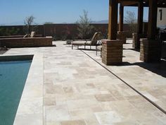 a patio with chairs and a swimming pool