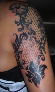 a woman with a black and white tattoo on her arm