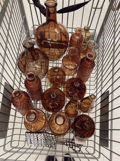 a shopping cart filled with lots of brown glass bottles