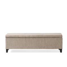 an upholstered bench with black legs and a light colored fabric cover on it