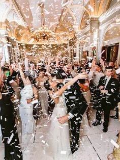 the newly married couple are surrounded by confetti