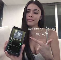 a woman pointing at her cell phone with the caption'me every day of my life '