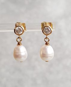 This stunning pair of dangle stud earring. Approximately 8x9mm white freshwater pearls, very good lustre on gold plated stud with cubic zirconia setting.  The earrings is approximately 2cm long The pearls are genuine freshwater pearls therefore each pearl is slightly different in shape, size and each pearl has it own unique natural blemishes The colour of the actual earrings might be slightly different to the photo due to the lighting  All measurement  mentioned in this listing is approximate Mo High Luster Drop Pearl Earrings For Anniversary, Anniversary Bridal Earrings With Pearl Drop In Yellow Gold, Anniversary Yellow Gold Bridal Earrings With Pearl Drop, Anniversary Bridal Earrings In Yellow Gold With Pearl Drop, Classic Pearl Drop Dangle Clip-on Earrings, Anniversary Teardrop Pearl Earrings With High Luster, Pearl Pendant Dangle Earrings For Anniversary, Pear-shaped Pearl Pendant Earrings For Anniversary, Anniversary Pearl Pendant Earrings