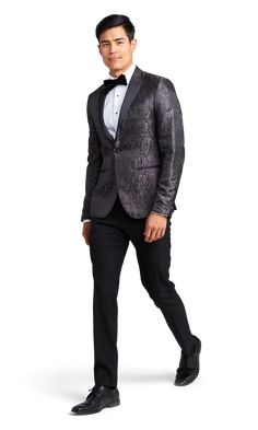 A slim paisley black tuxedo with one button and a peak lapel. Elegant Slim Fit Blazer For Party, Elegant Slim Fit Party Blazer, Elegant Single Button Tuxedo For Party, Black Single Breasted Tuxedo For Party, Black Notch Lapel Blazer For Party, Black Single-breasted Tuxedo For Party, Slim Fit Notch Lapel Blazer For Party, Black Single-breasted Party Tuxedo, Slim Fit Blazer With Notch Lapel For Parties