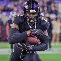 a football player holding a ball in his hands