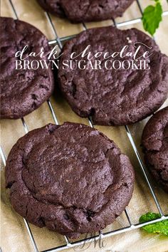 chocolate brownie cookies cooling on a wire rack with mint sprig in the background