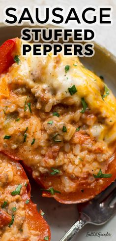 sausage stuffed peppers on a white plate with a fork and spoon in the background text reads, sausage stuffed peppers