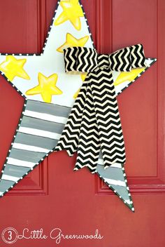 a paper star hanging on a red door