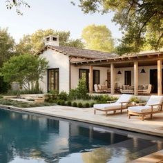 a house with a pool and lounge chairs in front of the patio, next to it