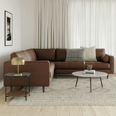 a living room filled with furniture and white curtains