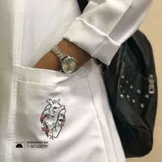 a close up of a person wearing a white shirt and black tie with a watch on their wrist