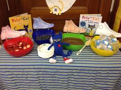 a table topped with bowls filled with fruit and books