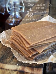 a stack of crackers sitting on top of a wooden table next to a jar of syrup