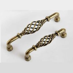 two antique style handles and pulls on a white background