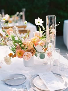 the table is set with flowers and silverware