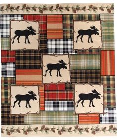 a quilt with moose and plaid squares on it