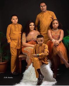 the family is posing for a photo in their orange outfits and white furnishs