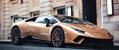 a tan colored sports car parked in front of a building on the side of the road