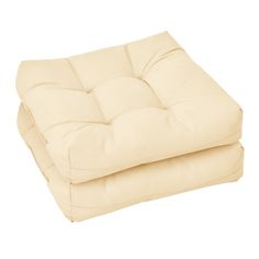 two white cushions sitting on top of each other