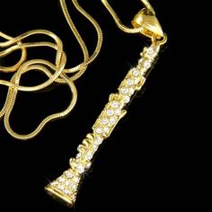 a gold necklace with an eiffel tower pendant