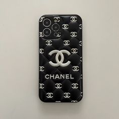 a chanel phone case is displayed on a white surface with black and white patterns