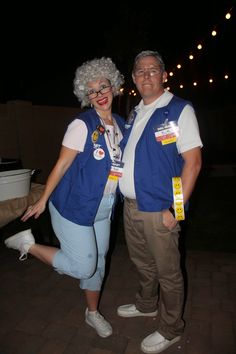 a man and woman dressed in costumes posing for the camera