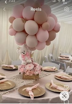 a table topped with lots of pink balloons and place settings for dinner or bridal party