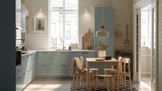 a dining table and chairs in a small kitchen