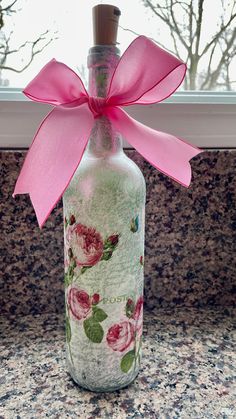 a glass bottle with a pink bow on it