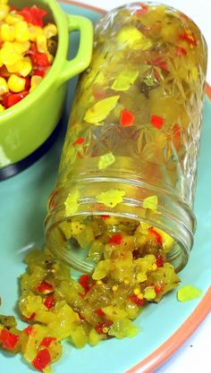 a jar filled with gummy bears next to a bowl full of candy