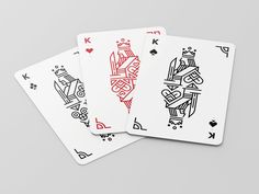 three playing cards with different designs on them