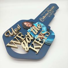 a blue and gold key shaped like a guitar with the words we are the world on it