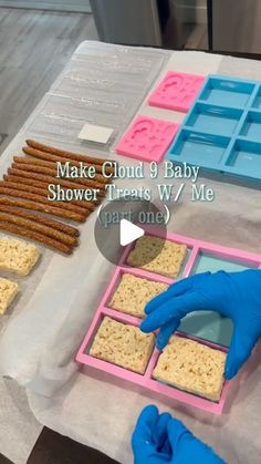 someone in blue gloves is making baby shower treats