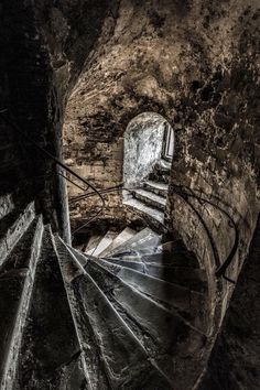 a spiral staircase in an old stone building