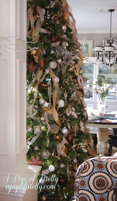 a christmas tree decorated with ribbons and ornaments