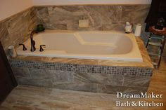 a bathroom with a bathtub and tile flooring