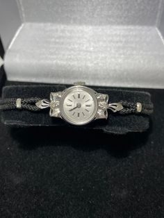 "Zodiac ladies 14kt white gold diamond wristwatch. This unique style watch features a textured bow set with a diamond in the center on the top and bottom of the case. 17 jewel wind up style watch with 17 jewel mechanical movement is in good working condition and keeps accurate time. This antique watch has been well cared for it still has the original winding crown. Custon fit for a 6.25\" wrist with a cord style band that I can make smaller but not larger. Beautiful working vintage solid gold ti Native American Turquoise Ring, Antique Watch, Cute Watches, Antique Watches, Style Watch, Fancy Diamonds, Bow Set, Mechanical Movement, Women Wrist Watch