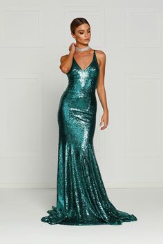 The Gigi Gown is a stunning mermaid fit dress with a v-neck and lace up back. The sequinned material is stretchy and it is lined to the hem. There is a hidden zipper on the back. What is a Made-To-Order? This product is a made-to-order item. Made-to-order items are not held in physical stock and production commences AFTER order placement. We try to limit production and stock levels and as such, made-to-order items produce less waste and allow you to purchase your dream gown without the chance of Glamorous V-neck Mermaid Dress With Fitted Bodice, V-neck Sequined Mermaid Dress For Gala, Green Sequin Fishtail Dress, Green Sequined Fishtail Dress, Green Fishtail Sequin Dress, Glamorous Mermaid Silhouette Dress With Sweep Train, Sequined Mermaid Hem Gown For Night Out, Glamorous Green Sequined Mermaid Dress, Glamorous Green Mermaid Dress With Sequins