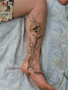 a woman's foot with tattoos on it