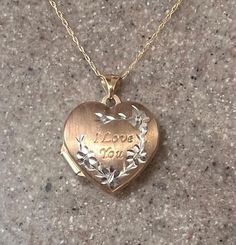 Vintage 10K Yellow Gold small heart locket with a lovely floral design. The words "I love you" are etched on the front. Opens with space on both sides for small photos or keepsakes. Locket measures about 3/4" at the widest, and 1" long. The chain is 18" long. Beautiful classic vintage piece! In good condition. Weighs 2.2 grams. Stamped 10K on the bail and on the clasp. Will ship in a gift box. Stock # S840 Heirloom Engraved Locket Necklace For Valentine's Day, Heirloom Locket Necklace For Valentine's Day Anniversary, 14k Stamped Heart Locket Necklace For Anniversary, Engraved Double Heart Locket Necklace For Anniversary, 14k Stamped Heart Pendant Locket Necklace For Anniversary, 14k Gold Heart-shaped Engraved Locket Necklace, Engraved Heart-shaped 14k Gold Locket Necklace, Engraved Heart Shaped 14k Gold Locket Necklace, Engraved 14k Gold Heart Locket Necklace