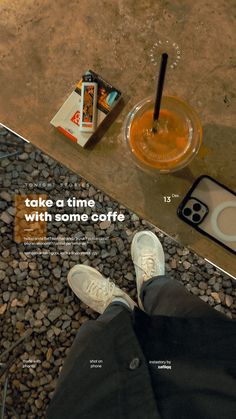 a person sitting on the ground with their feet up next to a cup of coffee