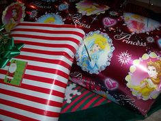 two presents wrapped in red and white striped wrapping paper with princesses on them sitting next to each other