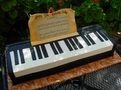 a cake made to look like an old piano with sheet music on it's top