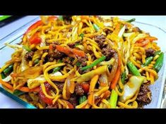 a glass dish filled with noodles and meat