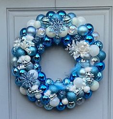 a blue and white christmas ornament wreath on a door